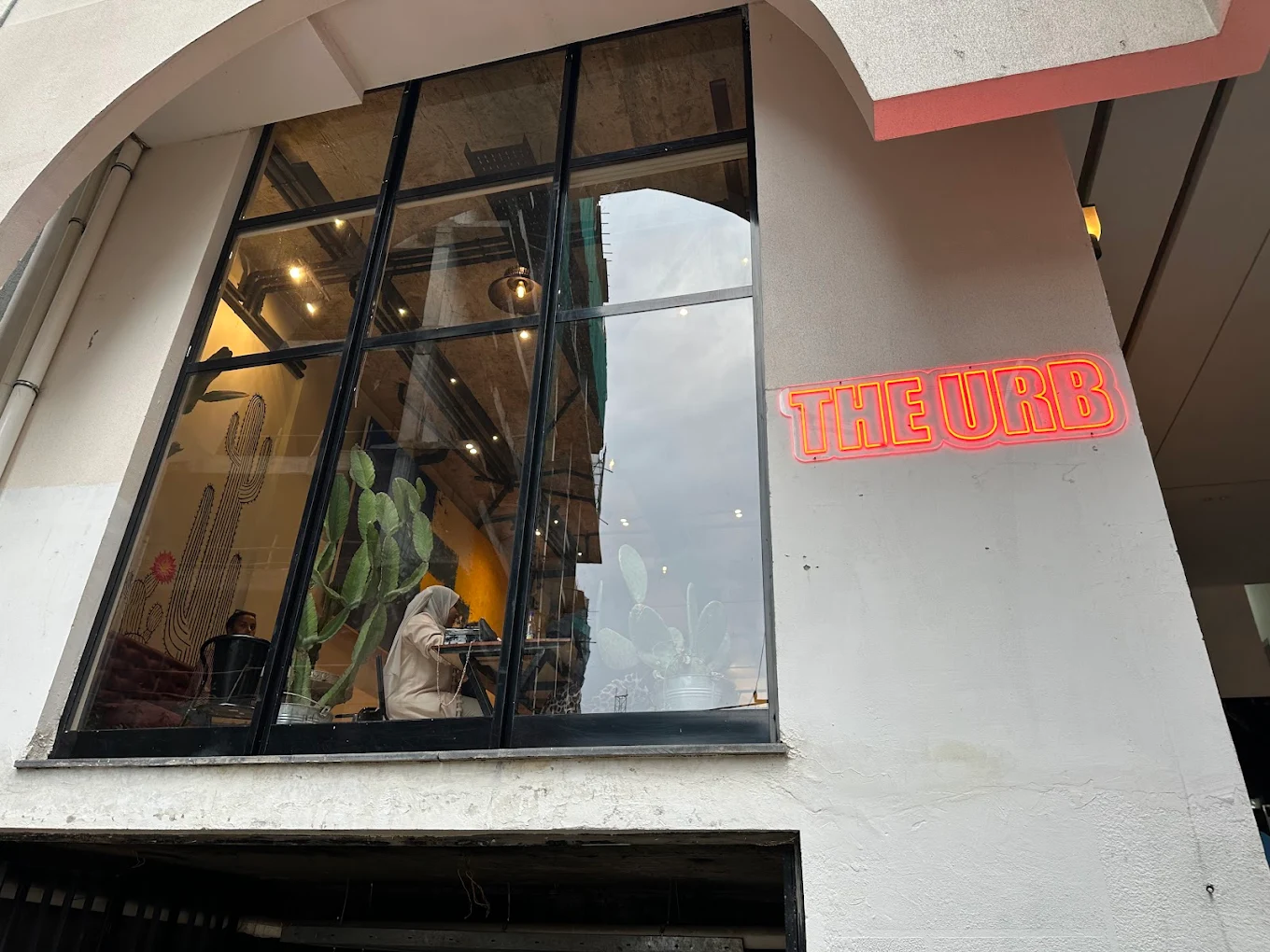 The Urb storefront in Bole with the neon sign glowing through the window