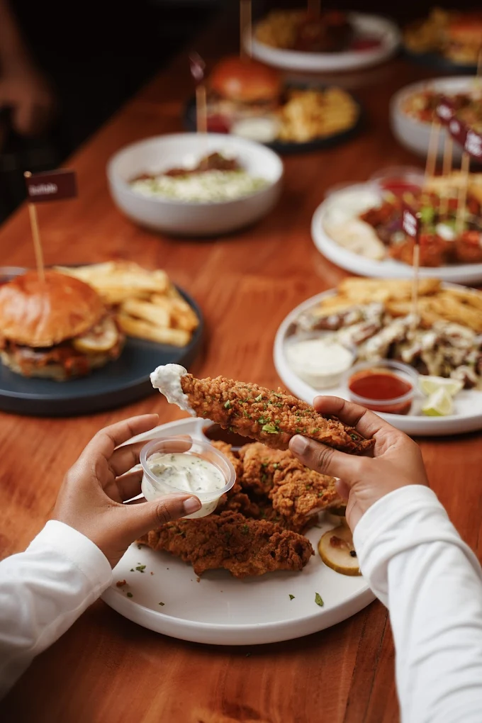 A table full of Urb plates and wings